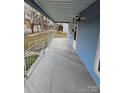 Inviting front porch with a metal railing at 414 S Yadkin Ave, Spencer, NC 28159