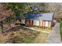 Aerial view of a brick ranch house with a driveway and yard at 4308 Glenfall Ave, Charlotte, NC 28210