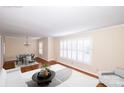 Virtually staged living room with hardwood floors and large windows at 4308 Glenfall Ave, Charlotte, NC 28210