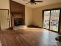 Living room featuring hardwood floors, a brick fireplace, and sliding glass doors at 4452 Huntington Dr, Gastonia, NC 28056