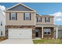 Two-story home with stone accents, a two-car garage, black shutters, and a well-manicured lawn at 4618 Harris Elliot Rd, Lincolnton, NC 28092