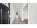 Bright hallway with wood-look floors, white walls, and doors that lead to other parts of the house at 4618 Harris Elliot Rd, Lincolnton, NC 28092