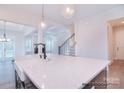 Island kitchen with white quartz countertops and farmhouse sink at 558 Edmunds Ln # 41, Clover, SC 29710