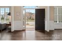 View from front room, showing hardwood flooring and freshly painted walls, leading into an open door at 8509 Penton Pl, Harrisburg, NC 28075