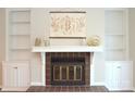 Living room fireplace with built-in shelving and a neutral color scheme at 9041 J M Keynes Dr # 10, Charlotte, NC 28262