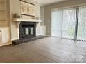 Spacious living room with tile floors, fireplace and sliding glass doors at 9041 J M Keynes Dr # 10, Charlotte, NC 28262