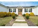 Inviting home with a stone walkway, white siding, solar panels and a well-manicured front yard at 9489 Westridge Dr, Hickory, NC 28601