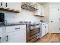 Modern kitchen featuring stainless steel appliances, white cabinets, and granite countertops at 9489 Westridge Dr, Hickory, NC 28601