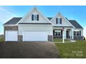 Two-story house with beige siding, stone accents, and a two-car garage at Lot 1 Glenview Meadow Dr # Arcadia, Waxhaw, NC 28173