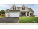 Ranch house with beige siding, dark red trim, and a two-car garage at Lot 1 Glenview Meadow Dr # Arcadia, Waxhaw, NC 28173