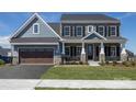 Two-story home with blue siding, stone accents, and a two-car garage at Lot 1 Glenview Meadow Dr # Notthingham, Waxhaw, NC 28173