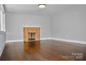 Living room with hardwood floors and brick fireplace at 1007 W Horah St, Salisbury, NC 28144