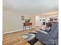 Living room with hardwood floors and access to dining and kitchen areas at 11023 Alderbrook Ln, Charlotte, NC 28270