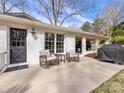 Outdoor patio featuring comfortable seating, adjacent to a carport, and offering an ideal spot for relaxation at 1116 Circlewood Dr, Charlotte, NC 28211