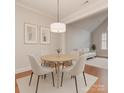 Cozy dining area with modern lighting, neutral decor, and hardwood floors at 11756 Easthampton Cir, Charlotte, NC 28277