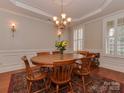 Elegant dining room with round table, chandelier, and hardwood floors at 11756 Easthampton Cir, Charlotte, NC 28277