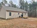 Home's back features a deck, wooded area, and spacious yard at 1194 Great Falls Hwy, Chester, SC 29706