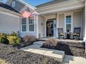 Inviting front porch with rocking chairs and American flag at 12612 Es Draper Dr, Huntersville, NC 28078
