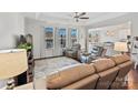 Open concept living room with kitchen view and gray recliners at 12612 Es Draper Dr, Huntersville, NC 28078