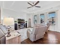 Spacious living room with gray leather recliners and a fireplace at 12612 Es Draper Dr, Huntersville, NC 28078