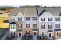 Well-maintained townhome exterior showing a mix of stone and siding with a manicured lawn at 1419 Newell Towns Ln, Charlotte, NC 28262