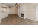 Open-concept living room with a fireplace, wood floors, and neutral color scheme at 14967 Santa Lucia Dr, Charlotte, NC 28277