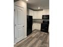 Modern kitchen with white cabinets, granite countertops, and black appliances at 155 Trail Wood Ct, Salisbury, NC 28146