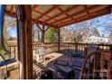Covered porch with wood railings and an assortment of patio furniture at 2021 Willis Dr, Shelby, NC 28152