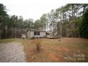 Tan mobile home with wooden deck and gravel driveway at 210 Barbary Dr, Statesville, NC 28677