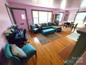 Bright living room with hardwood floors, large windows, and comfortable seating arrangement at 308 N Hawthorne St, Mount Holly, NC 28120
