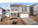 Two-story house with brick and siding, attached garage, and a well-manicured lawn at 3914 Waxahachie Ave, Charlotte, NC 28214