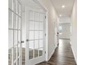 Bright hallway with hardwood floors and French doors at 4622 Harris Elliot Rd, Lincolnton, NC 28092