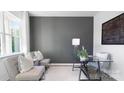 Home office with glass-top desk, gray accent wall, and comfortable seating at 4622 Harris Elliot Rd, Lincolnton, NC 28092