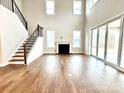 Two-story living room with hardwood floors, fireplace and sliding glass doors at 9811 Ardley Park Way # 30, Mint Hill, NC 28227