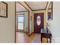 Inviting foyer with hardwood floors, an ornate front door, and warm lighting at 101 Griffin St, Stanley, NC 28164