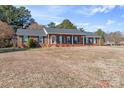 Attractive brick home enhanced with green shutters, highlighted by a wide, grassy front lawn at 101 Griffin St, Stanley, NC 28164