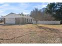 Home's exterior featuring a garage and a white picket fence at 101 Griffin St, Stanley, NC 28164