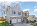 Two-story house with gray siding, stone accents, and a three-car garage at 10422 Ebbets Rd, Charlotte, NC 28273