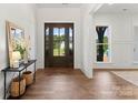 Bright and airy entryway features hardwood floors and a large wood front door at 114 Quail Ridge Dr, Mooresville, NC 28117