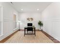 Bright home office with hardwood floors, wainscoting, and a desk at 114 Quail Ridge Dr, Mooresville, NC 28117