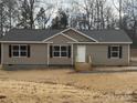 Tan house with gray roof, wood stairs, and black shutters at 118 Valley Springs Dr, Olin, NC 28660