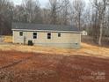 Rear view of a home with gray siding at 118 Valley Springs Dr, Olin, NC 28660