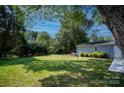 Large backyard with detached garage and lush green grass at 11828 Mirror Lake Dr, Charlotte, NC 28226