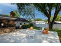 Spacious patio with fire pit, seating area, and a screened porch at 11828 Mirror Lake Dr, Charlotte, NC 28226