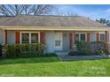 A welcoming entrance featuring a covered front porch and neatly trimmed hedges at 11828 Mirror Lake Dr, Charlotte, NC 28226