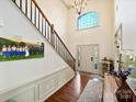 Two-story entryway with hardwood floors, a staircase, and lots of natural light at 12434 Kemerton Ln, Huntersville, NC 28078