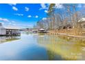 Scenic lake view featuring multiple covered docks and a tranquil reflection of the sky at 126 Abbey Ln, Mount Gilead, NC 27306