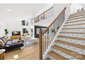 Modern staircase with geometric patterned risers and sleek metal railing at 126 Abbey Ln, Mount Gilead, NC 27306