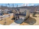 Two-story house on a tree-lined street with a basketball hoop at 13303 Hyperion Hills Ln, Charlotte, NC 28278