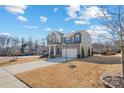 Two-story house with gray siding, brick accents, and a two-car garage at 13303 Hyperion Hills Ln, Charlotte, NC 28278